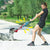 a woman playing tug of war toy with her dog - alternate view
