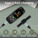 Black remote with colour display and four buttons next to an adjustable black collar receiver and USB-C cable.