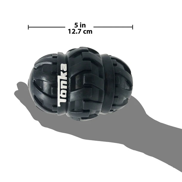 Durable interactive treat dispensing dog toy with a tire tread design for easy grip and long-lasting play.