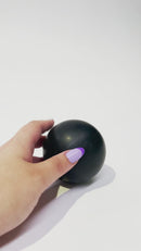 Pet owner holding the Strong Rubber Solid Ball, showing its compact size and easy-to-throw design for interactive play