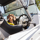 Small brown dachshund on boat wearing life jacket